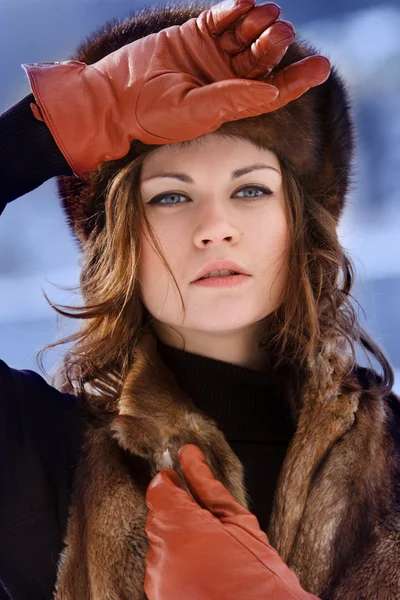 Young beautiful women in fur hat in winter forest — Stock Photo, Image