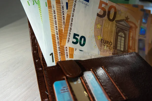 Euro cash is on the wallet with credit cards. A lot of money. Calculation of financial donations. Accounting of funds.Means of payment and wages in European currency.Balance account.Making purchases