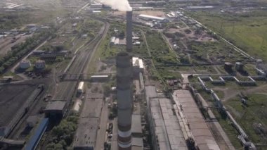 Smoky chimneys of the power plant aerial view.Electric power generation,power plant for burning coal.Thick smoke from fuel.Atmospheric pollution,harmful emissions and global warming,ecological problem
