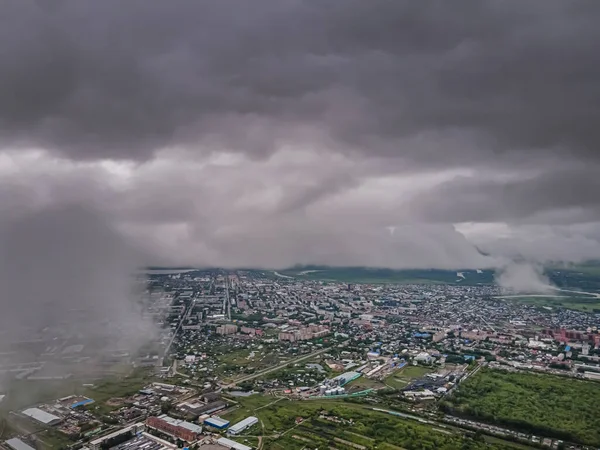 Flying through thick clouds. Rain clouds in the sky. Cumulus clouds, meteorology and climate studies.Photo  of the city from the height of clouds, aerial photography.Quadcopter,drone