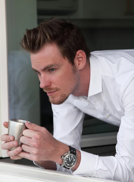 Man looking out of a window — Stock Photo, Image