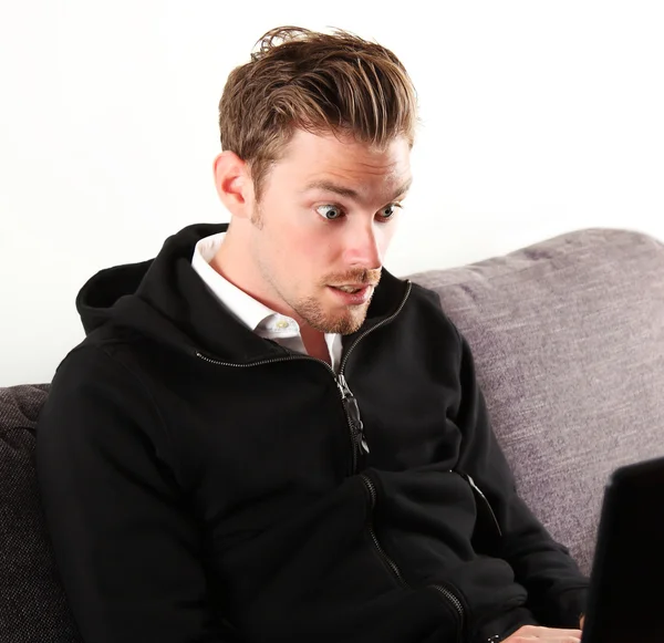 Young man looks surprised — Stock Photo, Image