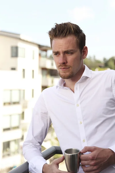 Man standing on balcony Stock Picture