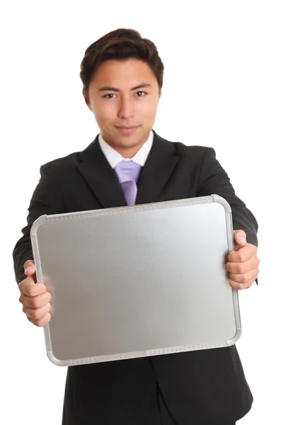 Businessman holding a chrome sign — Stock Photo, Image