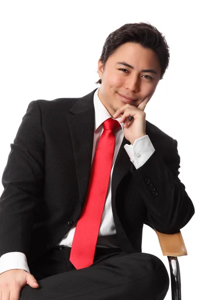 Satisfied businessman sitting in a chair — Stock Photo, Image