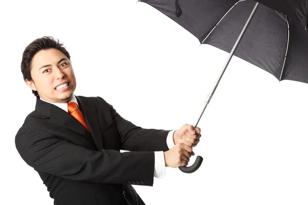 Homme d'affaires en colère avec parapluie — Photo