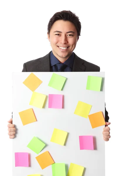 Good looking businessman with board — Stock Photo, Image