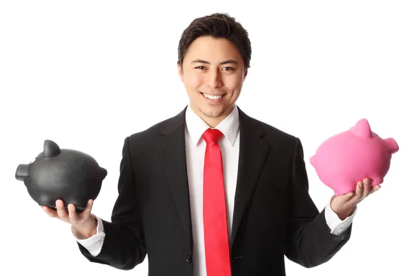 Attractive businessman with piggy banks — Stock Photo, Image