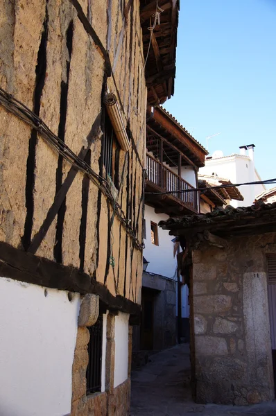 Fachada adobe y galeria de madera — Fotografia de Stock