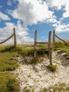 Difficult to climb wooden stile on the South Downs, Wilmington, East Sussex, UK - June 2022