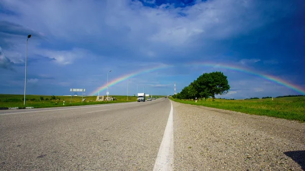 Rainbow above the road — Stock Photo, Image
