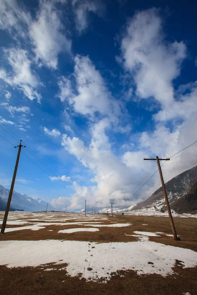 Power poles line towers in natural landscape — Stock Photo, Image