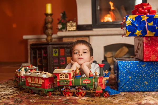 Child by fireplace — Stock Photo, Image