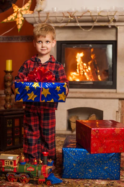 Child by fireplace — Stock Photo, Image