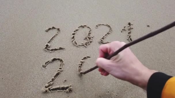 NEUES JAHR SCHRIFT 2022 UND ENDE 2021 MIT KRÖSEL AUF DEM BEACH SAND — Stockvideo