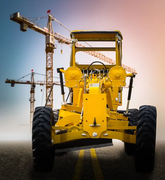 Old yellow motor grader on the road — Stock Photo, Image