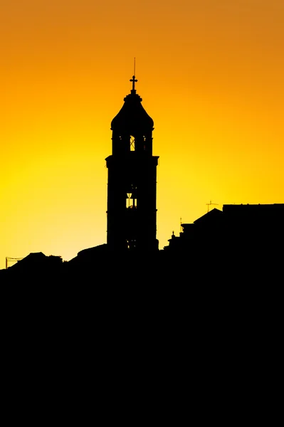 The silhouette of the city rooftops and church bell tower in Dub — Stock Photo, Image