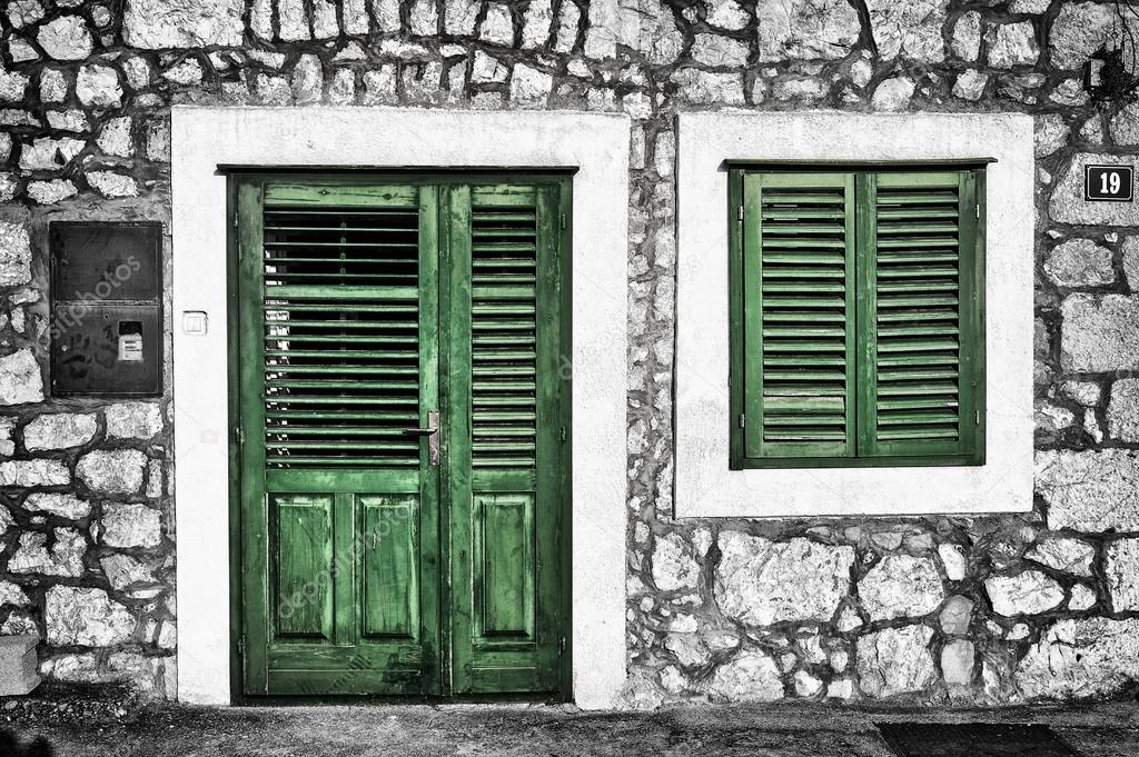 Decrepit green door and window on the Dalmatian house in Croatia