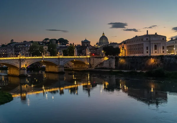 Rome sunset over Tiber and St Peters Basilica Vatican. Iconic landmarks of Rome, Italy\'s ancient capital city, reflecting in the tranquil waters of the River Tiber
