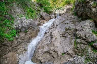 With its weathered crags and pinnacles, Rosengartenschlucht Canyon in Imst, Oberinntal Valley, is one of Austrias most spectacular natural sights. Rosengarten, literally Rose Garden, is a narrow chasm, incised into the rock by the cascading waters