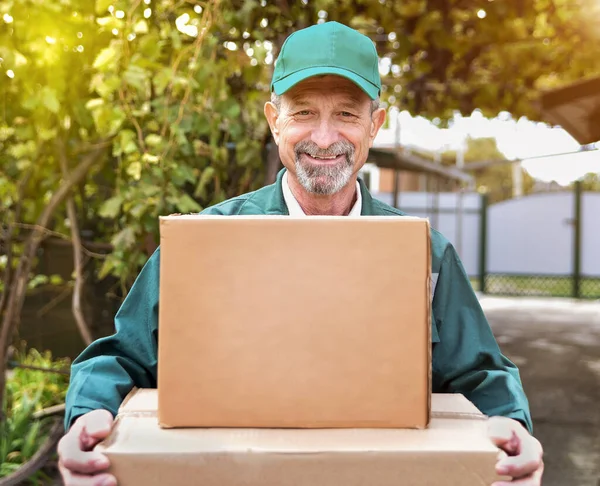 An elderly man delivers boxes with an order home
