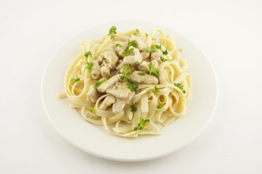 Beyaz tabakta tavuklu makarna.