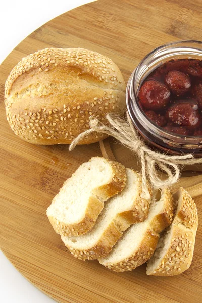 Still life with bread roll and jam — Stock Photo, Image