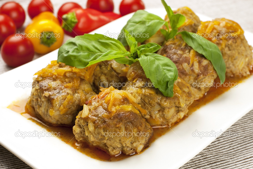 Plate of meatballs in gravy with herbs