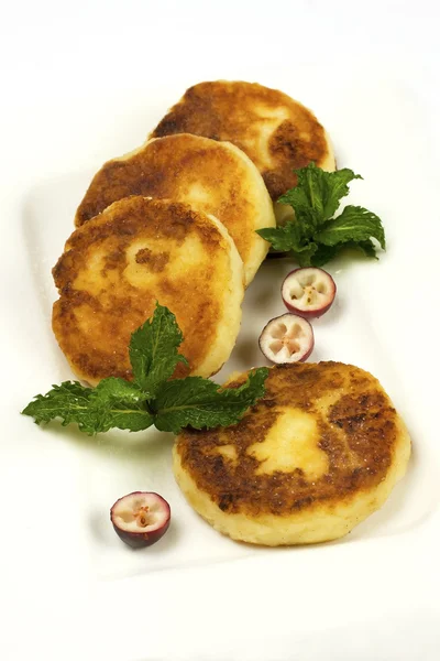 Cottage cheese pancakes on a white plate — Stock Photo, Image