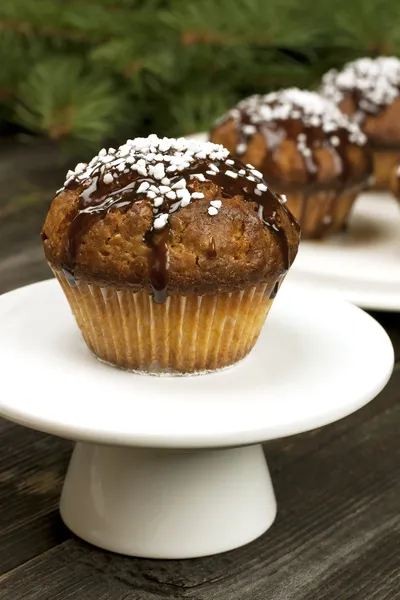 Christmas sweet muffins with chocolate glaze — Stock Photo, Image