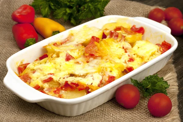 Vegetables baked with cheese in the pot on the table — Stock Photo, Image