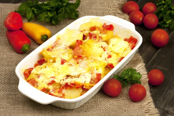 Vegetables baked with cheese in the pot on the table — Stock Photo, Image