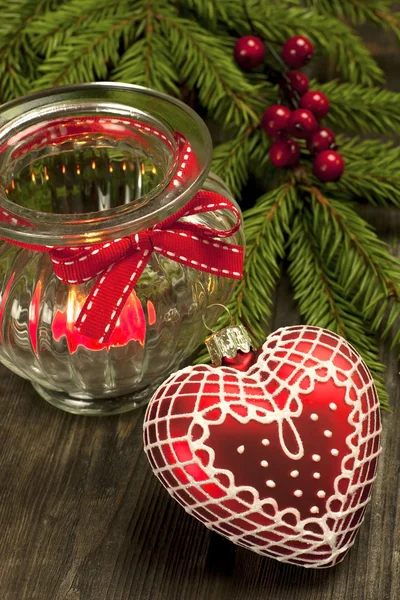 Christmas still life with candle and heart form decoration — Stock Photo, Image