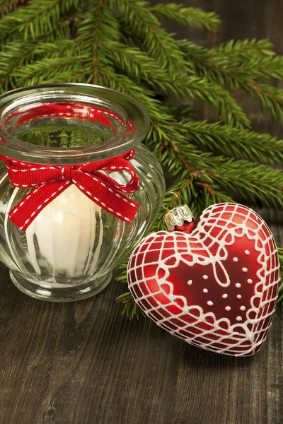 Christmas still life with candle and heart form decoration — Stock Photo, Image