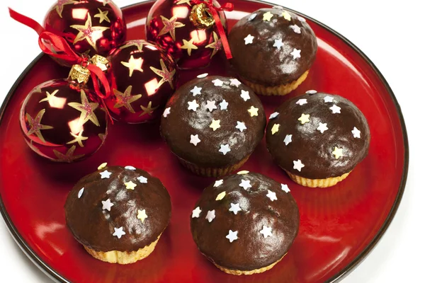 Chocolate muffins with christmas balls — Stock Photo, Image