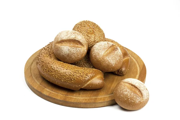 Assortment bread and buns on the wooden board — Stock Photo, Image