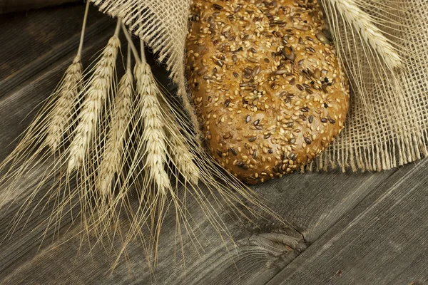 Freshly baked traditional bread on wooden board — Stock Photo, Image