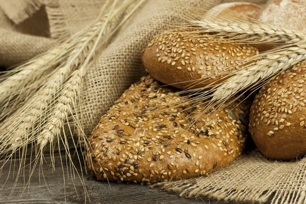 Freshly baked traditional bread on wooden board — Stock Photo, Image