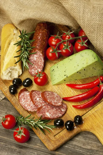 Baguette with salami and fresh cheese — Stock Photo, Image