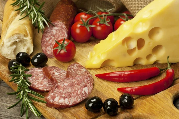 Baguette with salami and fresh cheese — Stock Photo, Image