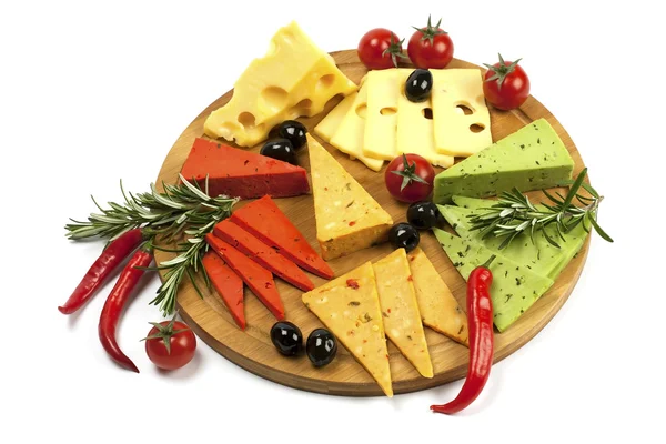 Various types of cheese on a wooden board — Stock Photo, Image