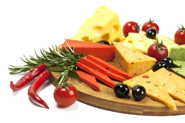 Various types of cheese on a wooden board — Stock Photo, Image