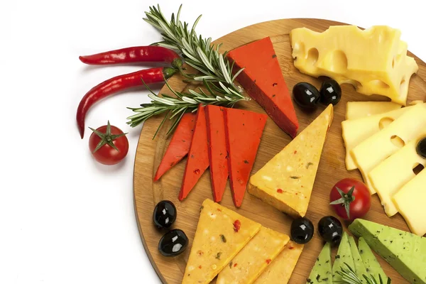 Various types of cheese on a wooden board — Stock Photo, Image
