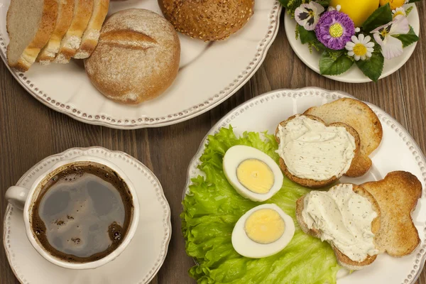 表的设置与煮熟的鸡蛋和面包与奶酪奶油和复活节装饰品 — 图库照片