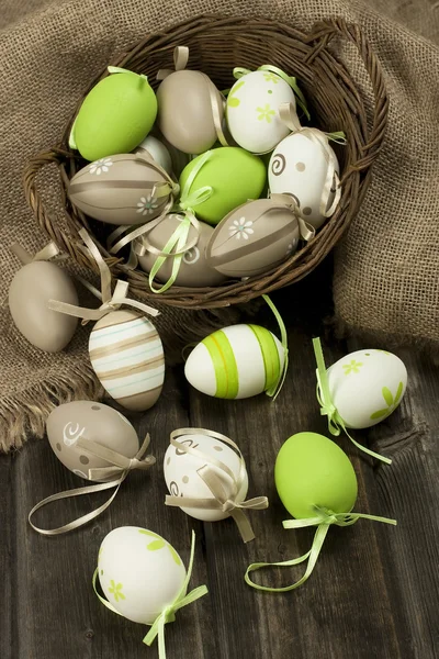 Easter eggs in the basket on rustic wooden surface — Stock Photo, Image