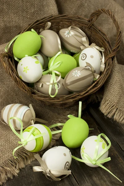 Easter eggs in the basket on rustic wooden surface — Stock Photo, Image