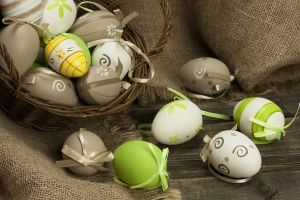 Easter eggs in the basket on rustic wooden surface — Stock Photo, Image