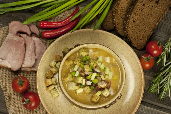 Pea soup with carrot and bacon in pot — Stock Image Pea soup with carrot and bacon in pot Stock Image