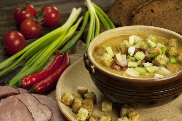 Pea soup with carrot and bacon in pot — Stock Image Pea soup with carrot and bacon in pot Stock Image