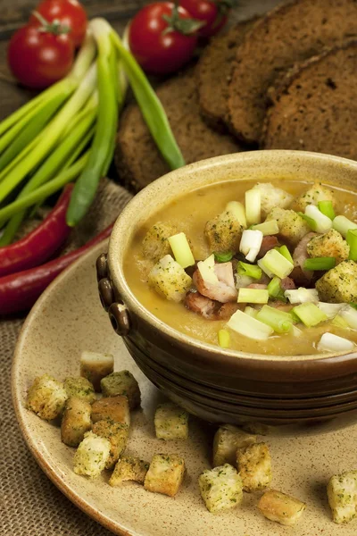 Pea soup with carrot and bacon in pot — Stock Image Pea soup with carrot and bacon in pot Royalty Free Stock Images